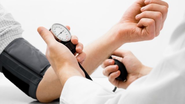 Patient and doctor taking high blood pressure